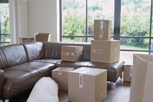 Professional movers efficiently packing household items.